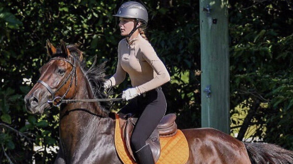 young rider approaching a jump