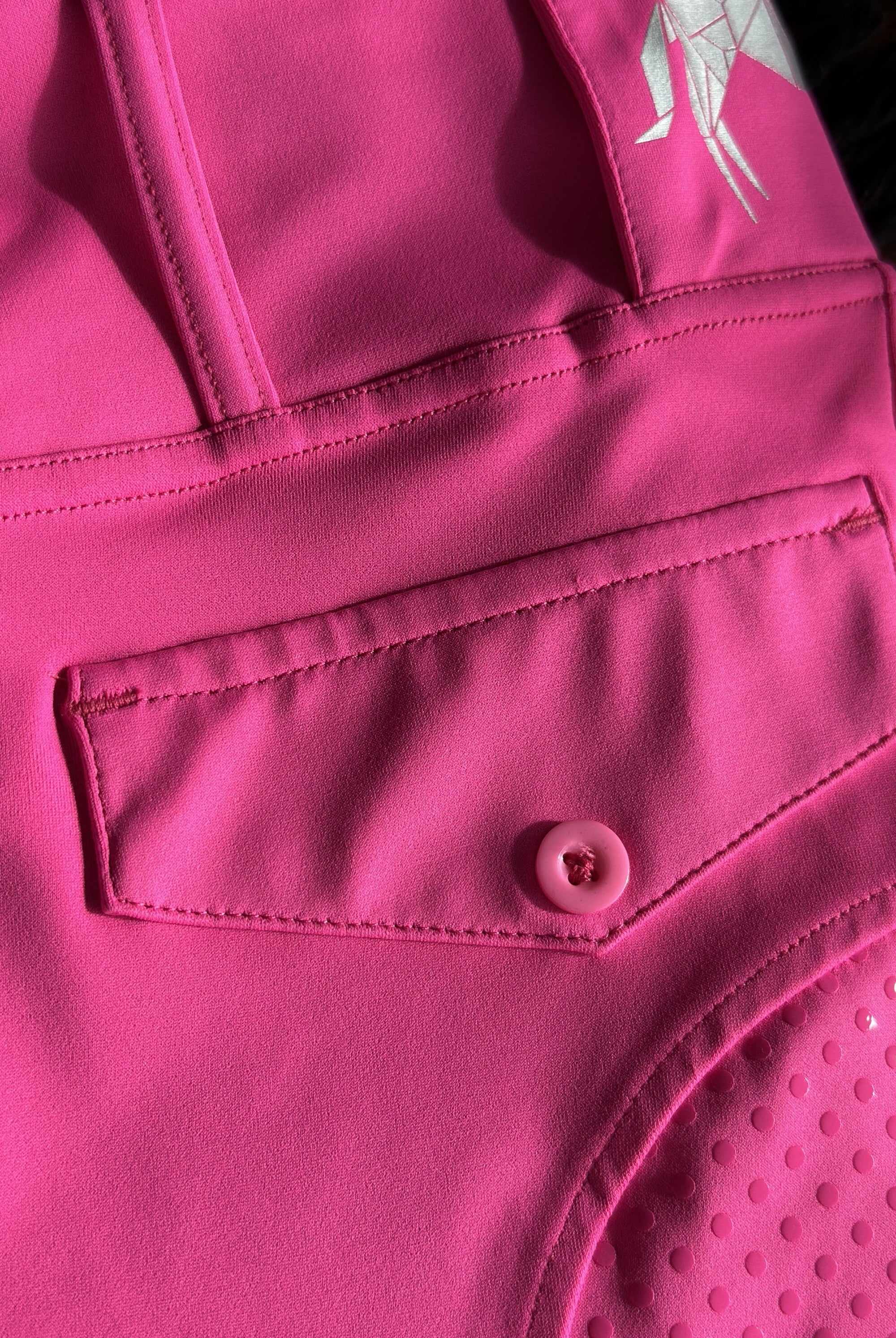 Close up of new style Hot Pink tights, showcasing the back pocket and belt loops