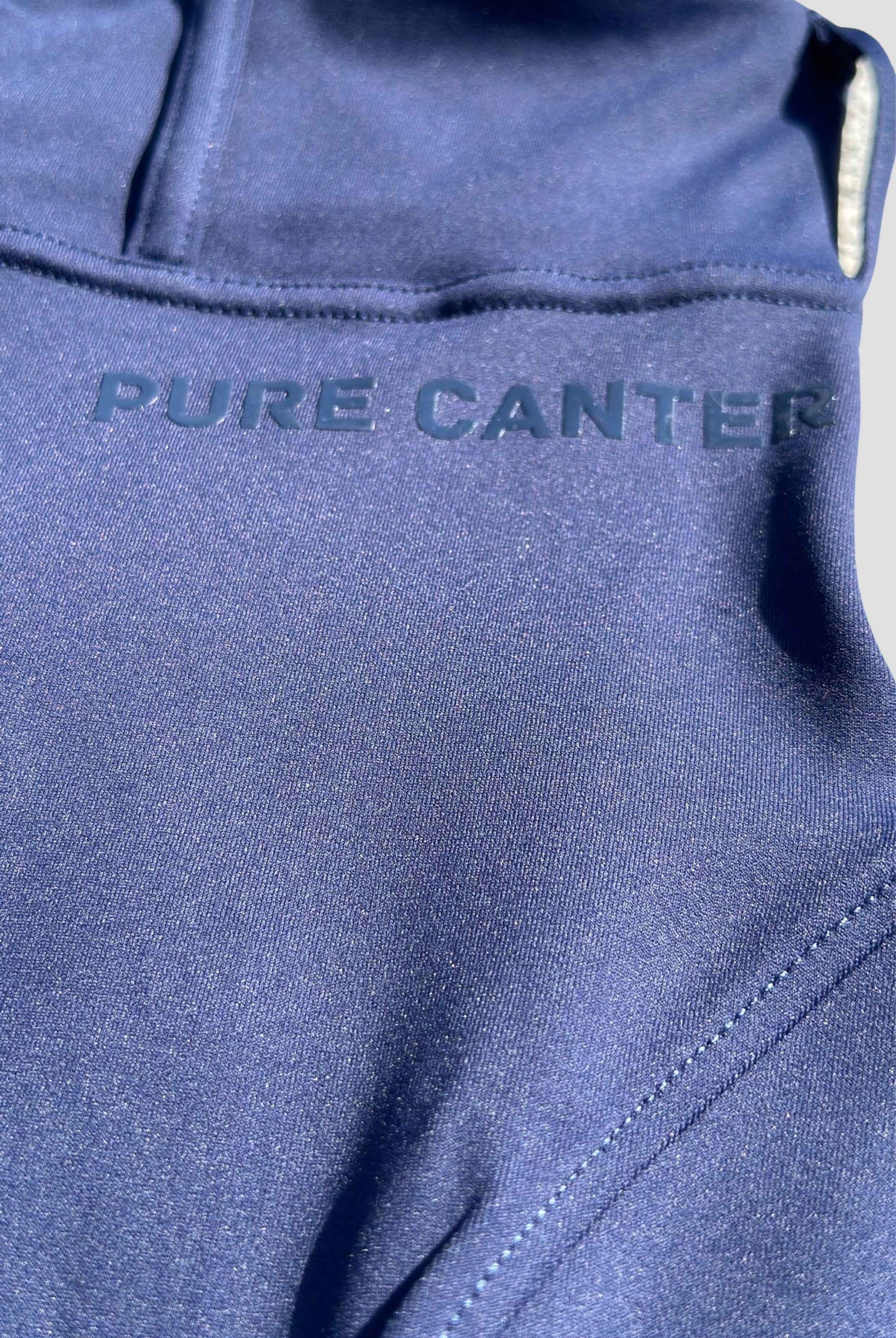 Front shot of G2 Navy riding tights, highlighting the silicone logo just beneath the waist