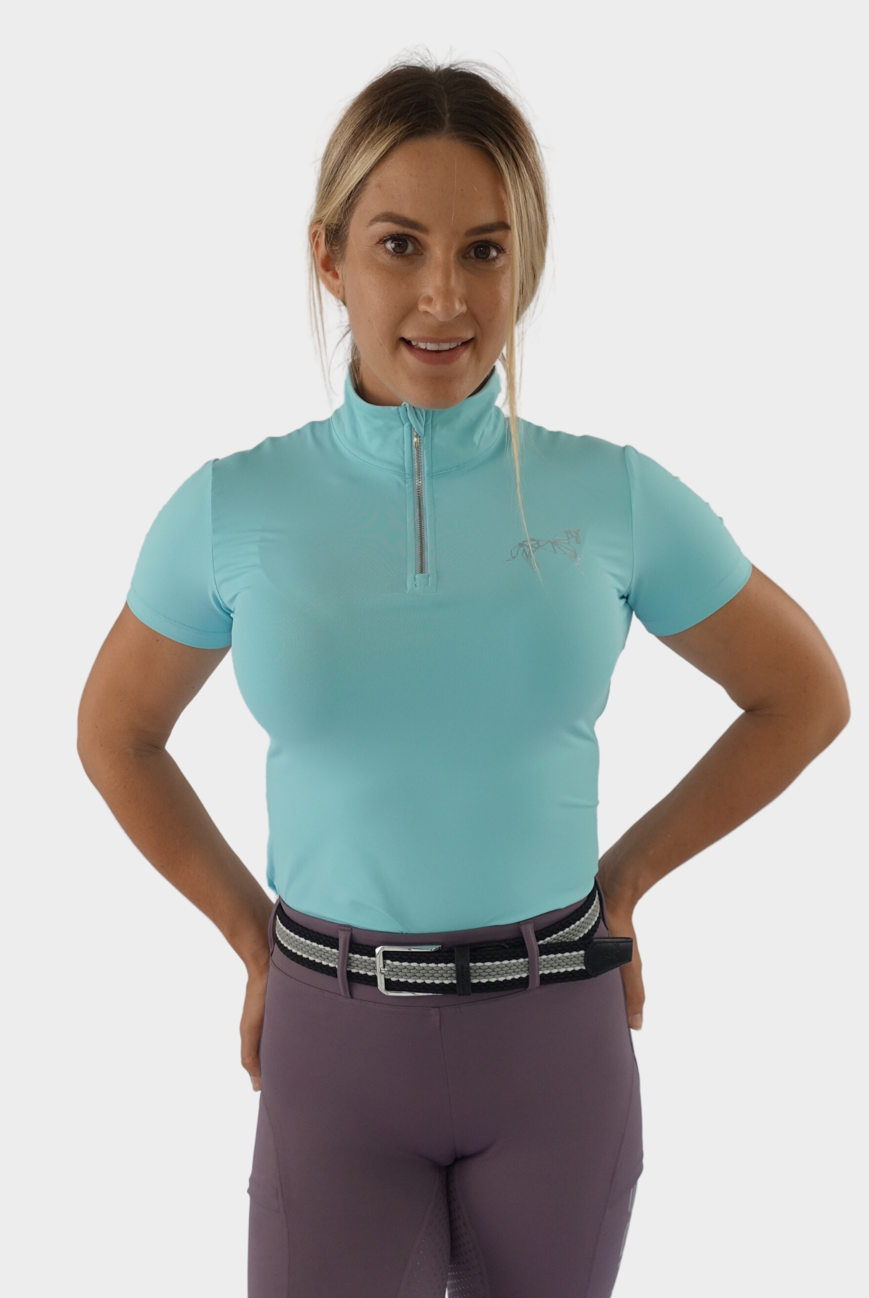 Vibrant ocean blue equestrian base layer with moisture-wicking fabric and a seamless design for a smooth and streamlined look.