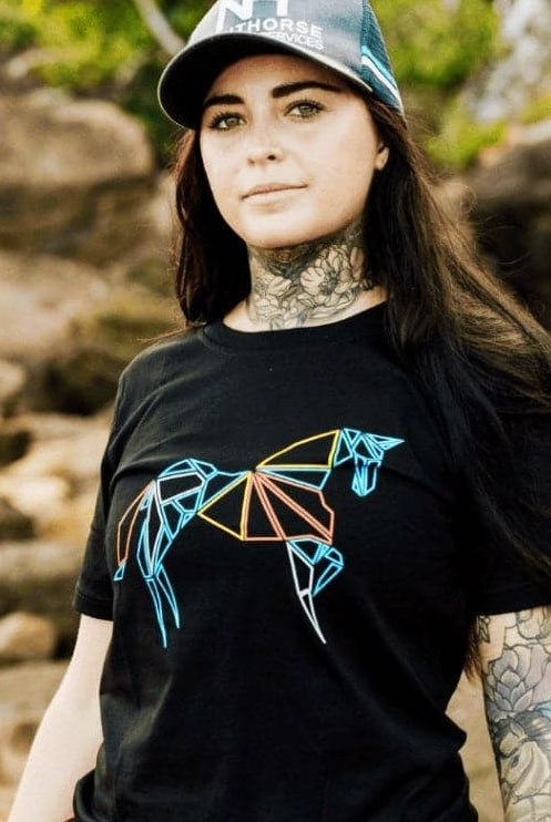 tattoed girl wearing a black shirt with colourful horse logo